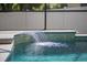 Tranquil waterfall feature spilling into the pool, creating a soothing ambiance for relaxation at 3415 Starbird Dr, Ocoee, FL 34761