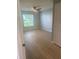 Bright bedroom featuring modern floors, fresh paint, and a large window at 3960 Southpointe Dr # 503, Orlando, FL 32822