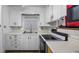 White cabinets line the kitchen walls, and feature a stove, oven and double sink at 434 Purdue St, Orlando, FL 32806