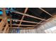 Fire damage to a home's exposed interior structure featuring charred wooden framing and ceilings, with a tarp overhead at 4421 Steed Ter, Winter Park, FL 32792
