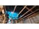 Fire-damaged home interior showing exposed wooden framing and roof structure with a blue protective tarp overhead at 4421 Steed Ter, Winter Park, FL 32792