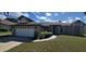 Well-maintained single-story home featuring a two car garage, manicured lawn, and covered entryway at 4421 Steed Ter, Winter Park, FL 32792