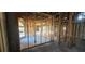 Unfinished living room showing the framing of the walls and ceiling with arched window at 4421 Steed Ter, Winter Park, FL 32792