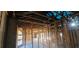 Unfinished living room showing the framing of the walls and ceiling with arched window at 4421 Steed Ter, Winter Park, FL 32792