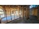 Unfinished living room showing the framing of the walls and ceiling with arched window at 4421 Steed Ter, Winter Park, FL 32792