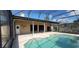 Large screened-in pool with surrounding patio, seamlessly blending indoor and outdoor living spaces at 4421 Steed Ter, Winter Park, FL 32792