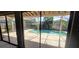 View of a private screened-in pool from the covered patio, perfect for year-round enjoyment at 4421 Steed Ter, Winter Park, FL 32792