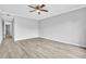 A neutral bedroom featuring wood-look floors and ceiling fan at 5122 Cypress Creek Dr # 103, Orlando, FL 32811