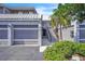 Charming townhome featuring a garage, private entry staircase, and mature landscaping at 5122 Cypress Creek Dr # 103, Orlando, FL 32811