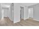Hallway featuring updated flooring, neutral walls, and access to additional rooms at 5122 Cypress Creek Dr # 103, Orlando, FL 32811