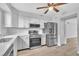 Updated kitchen with stainless steel appliances, stylish white cabinets, and modern lighting at 5122 Cypress Creek Dr # 103, Orlando, FL 32811