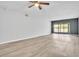 Bright living room with wood-look floors and sliding glass doors to the outside at 5122 Cypress Creek Dr # 103, Orlando, FL 32811