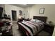 Comfortable bedroom featuring a queen-sized bed, closet space, and natural lighting at 5520 Solterra Cir, Davenport, FL 33837