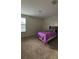 Bedroom with carpet flooring, one bed and a window offering natural light at 5520 Solterra Cir, Davenport, FL 33837