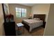 Cozy bedroom with a queen-sized bed, natural light, and a warm, inviting atmosphere at 5520 Solterra Cir, Davenport, FL 33837