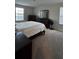 Neutral bedroom with carpet floors, filled with natural light, and features wooden furniture at 5520 Solterra Cir, Davenport, FL 33837