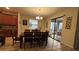 Inviting dining room with a wooden table, chandelier, and access to the patio at 5520 Solterra Cir, Davenport, FL 33837