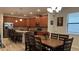 Spacious kitchen featuring stainless steel appliances, granite countertops, and wood cabinets, adjacent to the dining area at 5520 Solterra Cir, Davenport, FL 33837