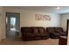 Inviting living room featuring plush seating, neutral walls, and seamless carpet flooring throughout at 5520 Solterra Cir, Davenport, FL 33837