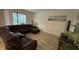 Cozy living room featuring a plush sectional sofa, wood floors, and natural light at 5520 Solterra Cir, Davenport, FL 33837