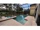 Beautiful screened-in pool and spa surrounded by lush landscaping and a private backyard at 5520 Solterra Cir, Davenport, FL 33837