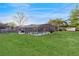 Lovely fenced backyard features a screened-in pool, green grass, and a shed on the property at 650 N 4Th Ave, Deltona, FL 32725