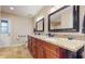 Modern bathroom features double sink vanity, granite countertop and framed mirrors at 650 N 4Th Ave, Deltona, FL 32725
