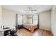Bedroom features wood floor, ceiling fan, and light-filled windows, perfect for relaxing or working at 650 N 4Th Ave, Deltona, FL 32725