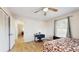 Bedroom features wood floor, ceiling fan, and light-filled windows, plus closet at 650 N 4Th Ave, Deltona, FL 32725
