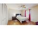 Well-lit bedroom with a ceiling fan, wood floors, and a cozy atmosphere at 650 N 4Th Ave, Deltona, FL 32725