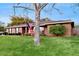 View of the brick home with a neatly kept lawn and American flag at 650 N 4Th Ave, Deltona, FL 32725