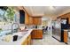 Bright kitchen featuring a stainless steel refrigerator and wood cabinets at 650 N 4Th Ave, Deltona, FL 32725