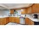 Traditional kitchen features wood cabinets, stainless steel dishwasher and white countertop at 650 N 4Th Ave, Deltona, FL 32725