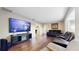 Spacious living room featuring hardwood floors and a large screen television at 650 N 4Th Ave, Deltona, FL 32725