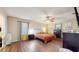 Bright primary bedroom features wood floors, a ceiling fan, and light-filled windows at 650 N 4Th Ave, Deltona, FL 32725