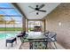 Cozy screened-in patio area with a dining table and access to the pool at 650 N 4Th Ave, Deltona, FL 32725
