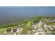 Aerial view of lakefront property near pond and houses in a neighborhood at 703 Valencia Shores Dr, Winter Garden, FL 34787