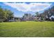 Expansive backyard shows both covered patios and a luscious lawn at 703 Valencia Shores Dr, Winter Garden, FL 34787