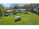 Wide open backyard with lush lawn and a golf cart sitting on the property at 703 Valencia Shores Dr, Winter Garden, FL 34787