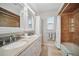 Bright bathroom featuring double sinks, granite countertops, white cabinets, and shower and tub combo at 703 Valencia Shores Dr, Winter Garden, FL 34787