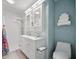 Bright bathroom features double sinks, white cabinets, and modern fixtures at 703 Valencia Shores Dr, Winter Garden, FL 34787