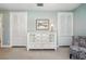 Neutral bedroom featuring built in cabinets, a chair and lamp and an art piece hanging on the wall at 703 Valencia Shores Dr, Winter Garden, FL 34787