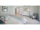 Spacious bedroom with large closets, a gray patterned chair and neutral decor at 703 Valencia Shores Dr, Winter Garden, FL 34787