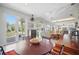 Open-concept dining area with bright lighting, outside access and living room view at 703 Valencia Shores Dr, Winter Garden, FL 34787