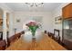 Well-lit dining room featuring hardwood floors, a large table and decorative art at 703 Valencia Shores Dr, Winter Garden, FL 34787