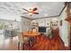 Dining room featuring hardwood floors, fireplace and views to the living room at 703 Valencia Shores Dr, Winter Garden, FL 34787