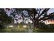 Charming single-story home featuring a lush front yard, mature oak tree, and inviting walkway at 703 Valencia Shores Dr, Winter Garden, FL 34787