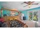 Fun game room features a tiki bar, foosball table, and easy access to the outdoors at 703 Valencia Shores Dr, Winter Garden, FL 34787