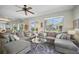 Open living room with tile flooring, plenty of windows, and access to the patio at 703 Valencia Shores Dr, Winter Garden, FL 34787