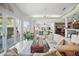 Bright living room with a ceiling fan, ample windows, and an open, airy floor plan at 703 Valencia Shores Dr, Winter Garden, FL 34787